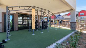 a fitness center with weights and equipment and a building with a patio at Weylyn Luxury Apartments, Arizona, 85339
